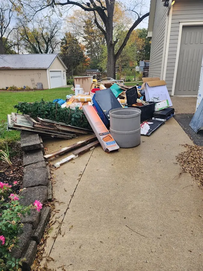 Dumpster being loaded with debris for Estate Cleanout Dumpster Rental in Beachwood